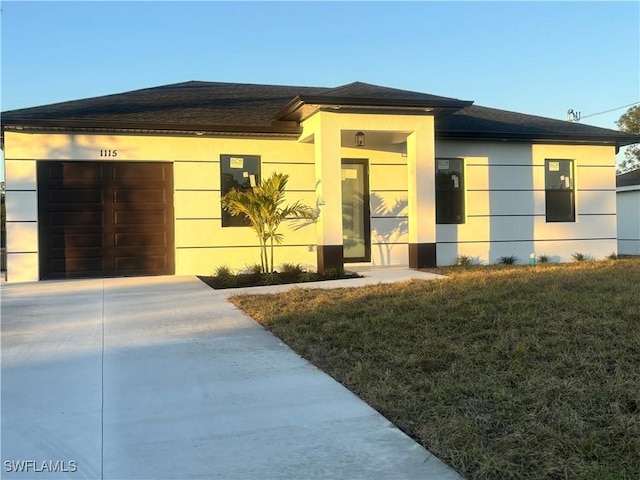 view of front of house with a garage and a front yard