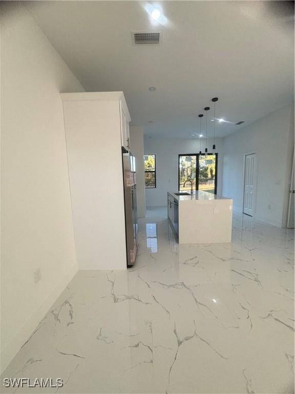 1115 Cumming St E, Lehigh Acres, FL 33974 - unfurnished room with light marble finish floors and recessed lighting