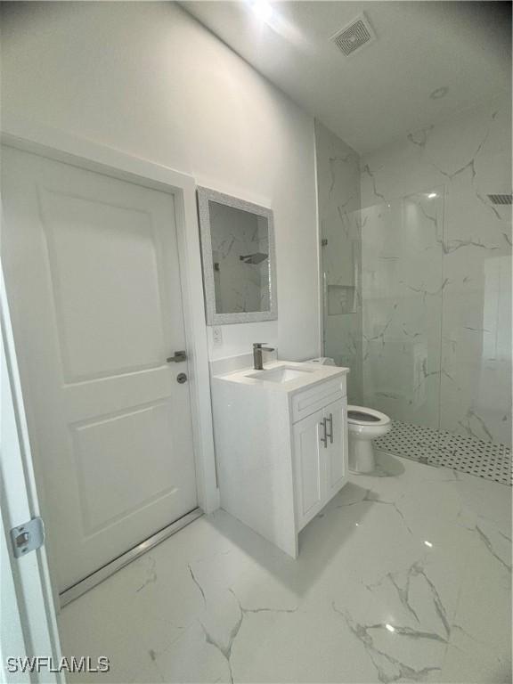 1115 Cumming St E, Lehigh Acres, FL 33974 - full bath with marble look tiles, vanity, and a marble finish shower