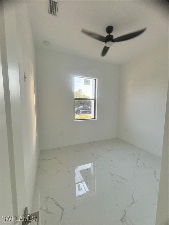 1115 Cumming St E, Lehigh Acres, FL 33974 - empty room featuring marble tiled flooring and a ceiling fan
