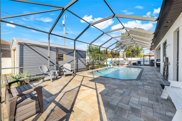 view of pool with a patio and glass enclosure