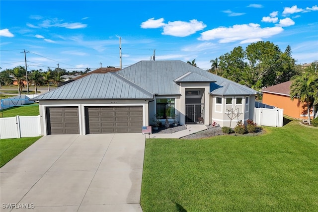 view of front of property featuring a garage and a front yard