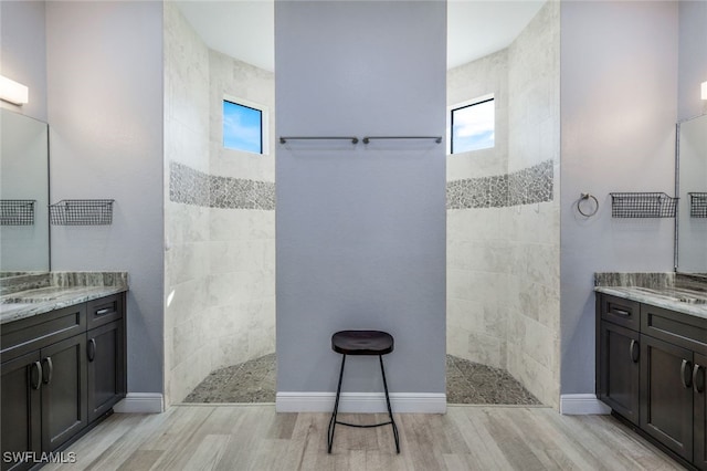 bathroom with a healthy amount of sunlight, wood-type flooring, and vanity