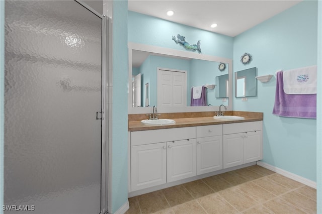 bathroom featuring tile patterned floors, vanity, and an enclosed shower