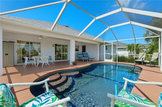 view of swimming pool featuring ceiling fan, a lanai, and a patio