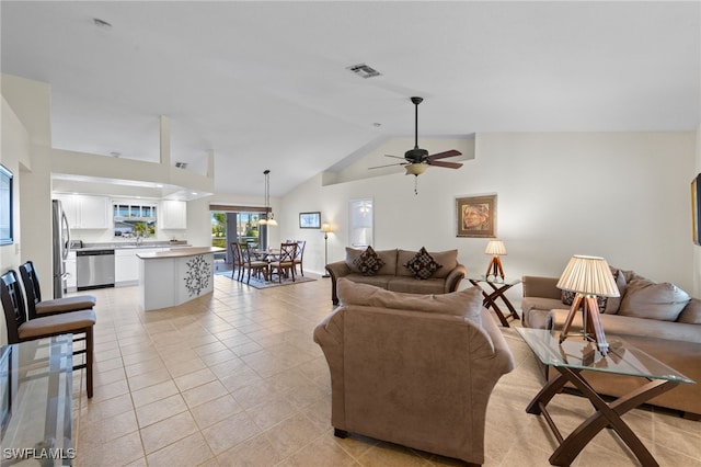 tiled living room featuring ceiling fan, sink, and high vaulted ceiling