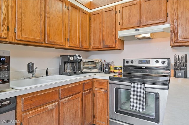 kitchen with stainless steel range with electric stovetop and sink