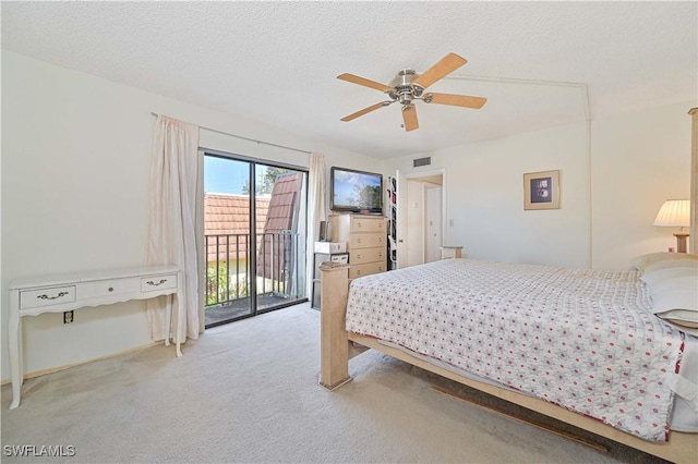 bedroom with access to outside, ceiling fan, light colored carpet, and a textured ceiling