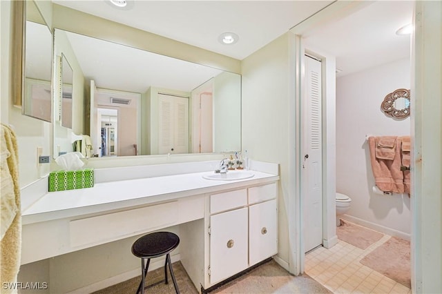 bathroom with vanity and toilet