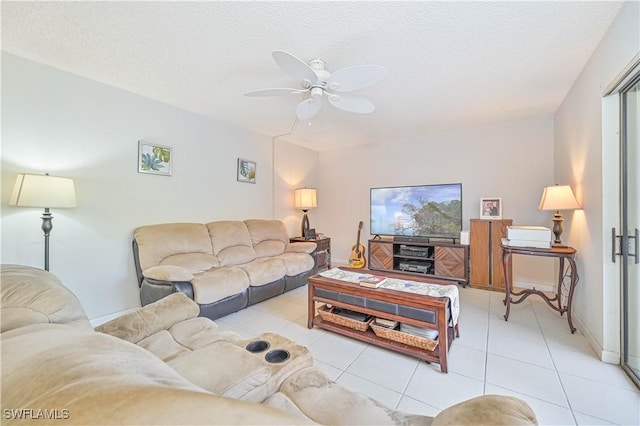 tiled living room featuring ceiling fan and a textured ceiling