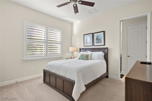 bedroom with ceiling fan and light carpet