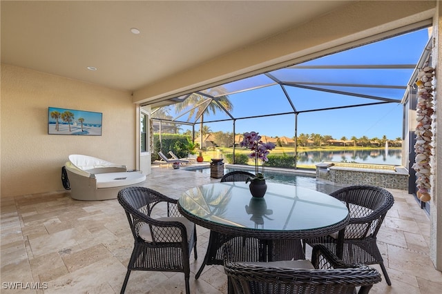 view of patio / terrace with a jacuzzi, a water view, and glass enclosure