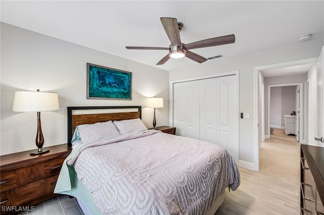 bedroom featuring a closet, light hardwood / wood-style flooring, and ceiling fan