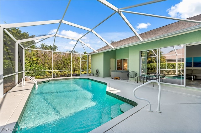 view of swimming pool with a lanai and a patio