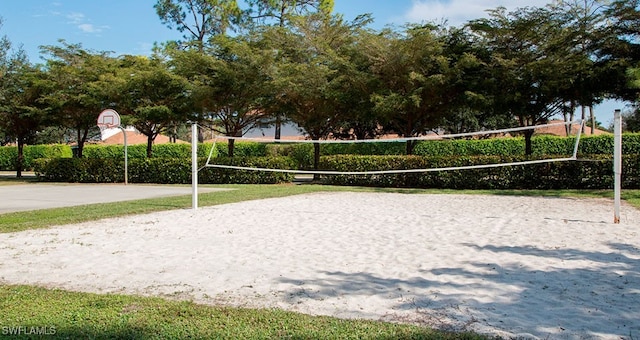 view of community with basketball hoop and volleyball court