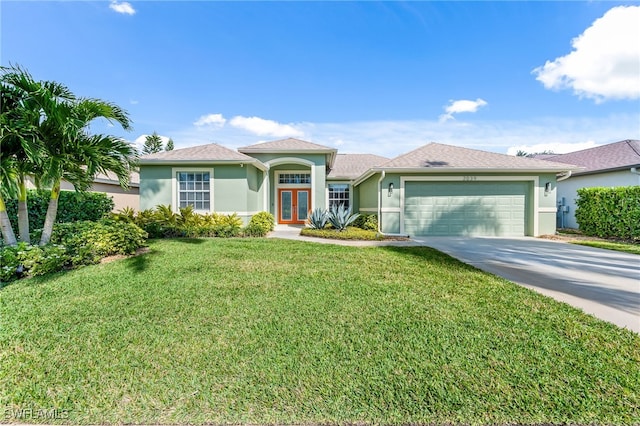 view of front facade with a front yard, french doors, and a garage