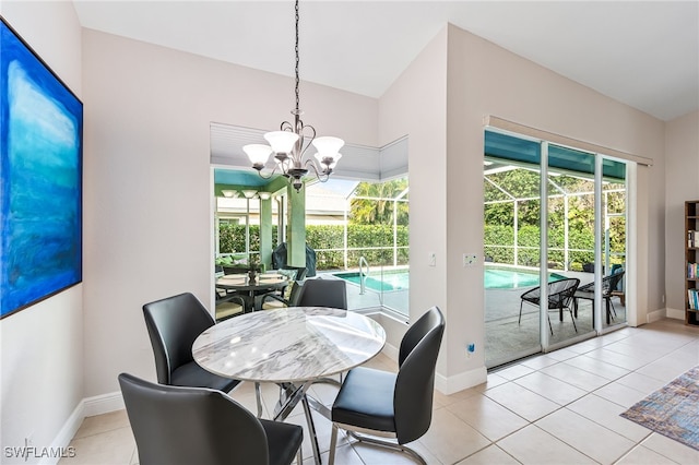 dining area featuring light tile patterned floors and an inviting chandelier