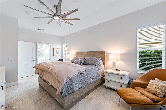 bedroom with connected bathroom and ceiling fan