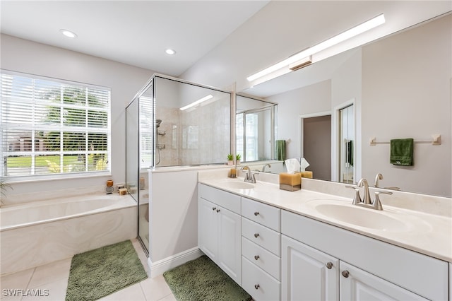 bathroom with vanity, tile patterned flooring, and plus walk in shower