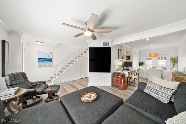 living room featuring crown molding, french doors, ceiling fan, and light wood-type flooring