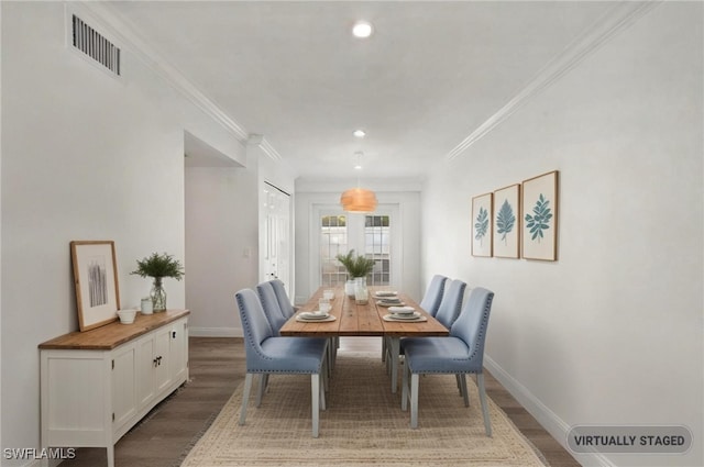 dining room featuring hardwood / wood-style flooring and ornamental molding