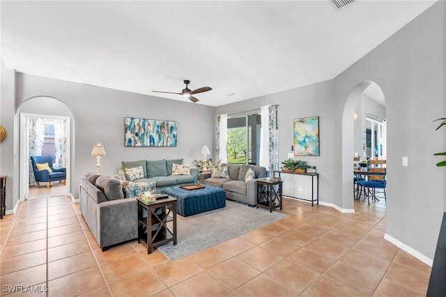 tiled living room featuring ceiling fan