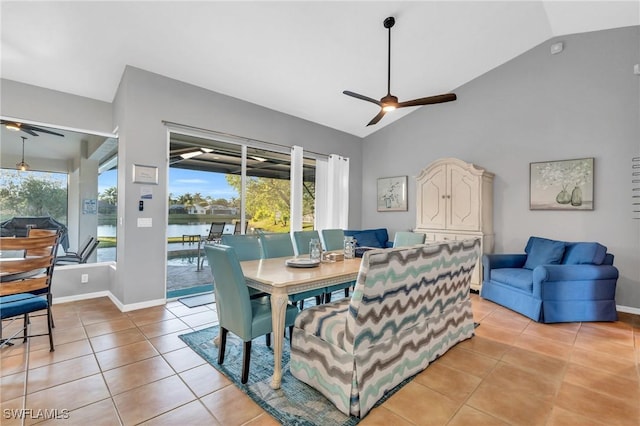 dining space featuring light tile patterned floors, a water view, ceiling fan, and lofted ceiling