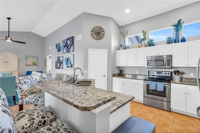 kitchen featuring stainless steel appliances, a kitchen island with sink, ceiling fan, sink, and light tile patterned flooring