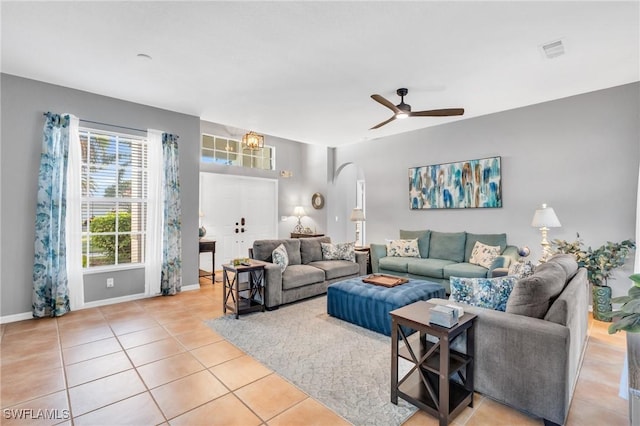 tiled living room featuring ceiling fan