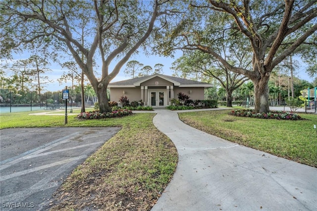 view of front of home featuring french doors and a front lawn