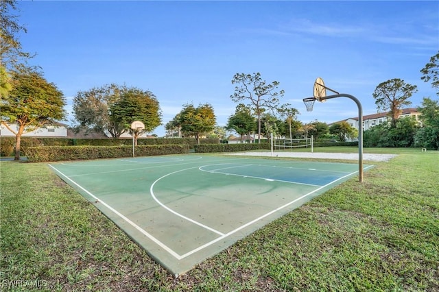 view of sport court with volleyball court and a lawn