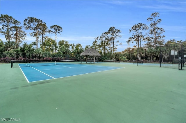 view of tennis court featuring a gazebo and basketball court