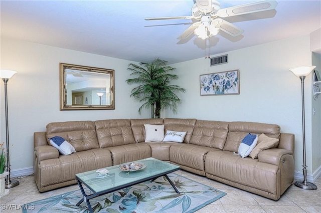 living area with light tile patterned floors, a ceiling fan, visible vents, and baseboards