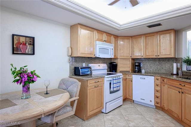 kitchen with visible vents, tasteful backsplash, white appliances, light tile patterned floors, and ceiling fan