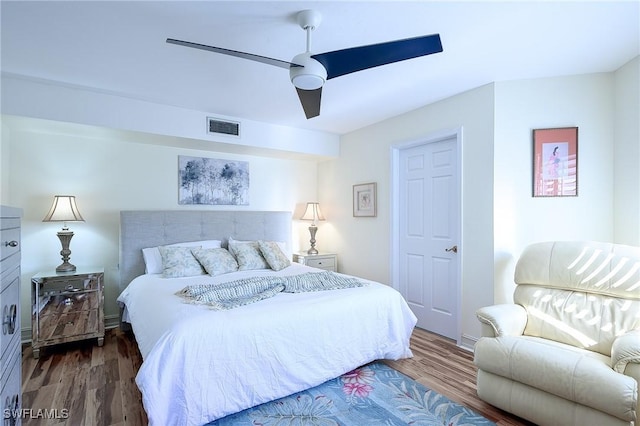 bedroom featuring a ceiling fan, wood finished floors, and visible vents