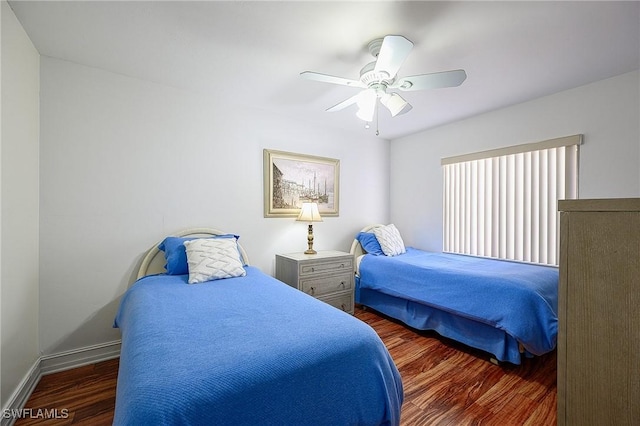 bedroom with a ceiling fan, wood finished floors, and baseboards