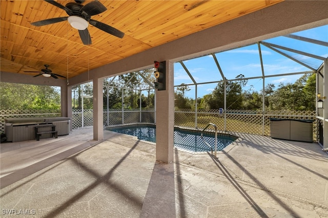 view of pool featuring a lanai, ceiling fan, a patio, and a hot tub