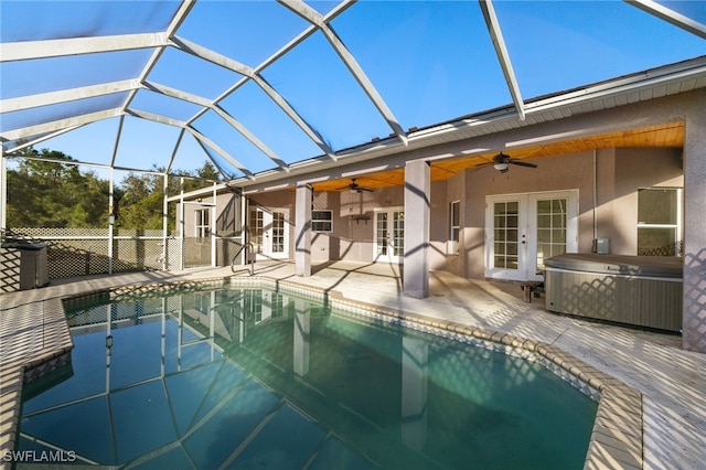 view of swimming pool featuring a patio area, ceiling fan, french doors, and glass enclosure