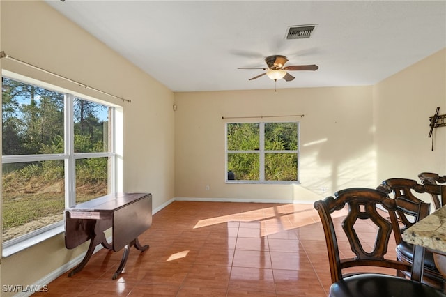 dining space with ceiling fan, plenty of natural light, and light tile patterned floors