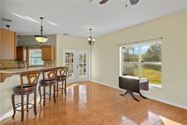 kitchen featuring pendant lighting, french doors, and a healthy amount of sunlight