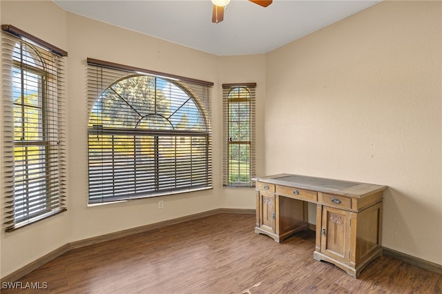 unfurnished office with ceiling fan and hardwood / wood-style flooring