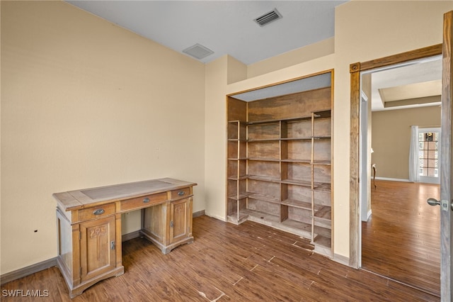 unfurnished office featuring hardwood / wood-style floors