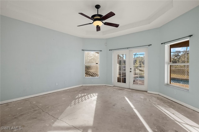 spare room featuring french doors, a raised ceiling, and ceiling fan