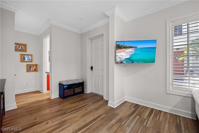 interior space with hardwood / wood-style floors, crown molding, and a healthy amount of sunlight