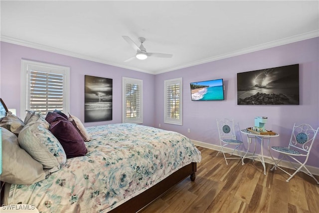 bedroom featuring multiple windows, ceiling fan, crown molding, and hardwood / wood-style flooring