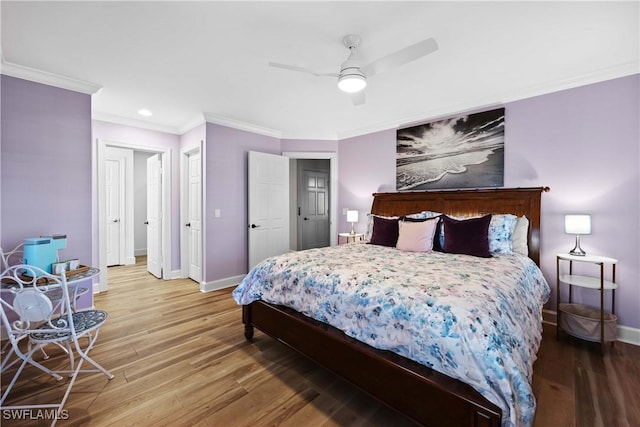 bedroom featuring hardwood / wood-style flooring, ceiling fan, and ornamental molding