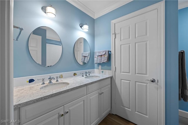 bathroom with hardwood / wood-style floors, vanity, and crown molding