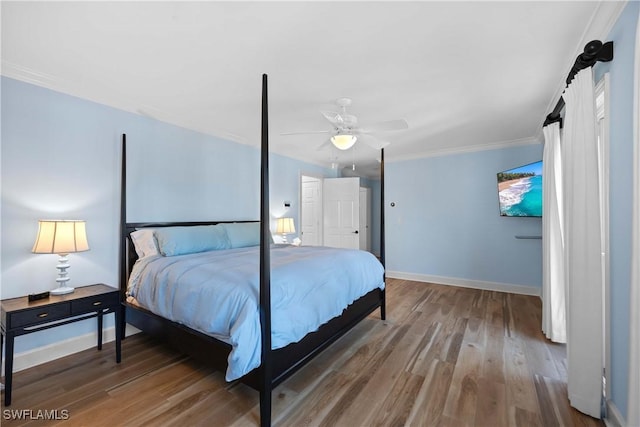 bedroom with ceiling fan, hardwood / wood-style floors, and crown molding