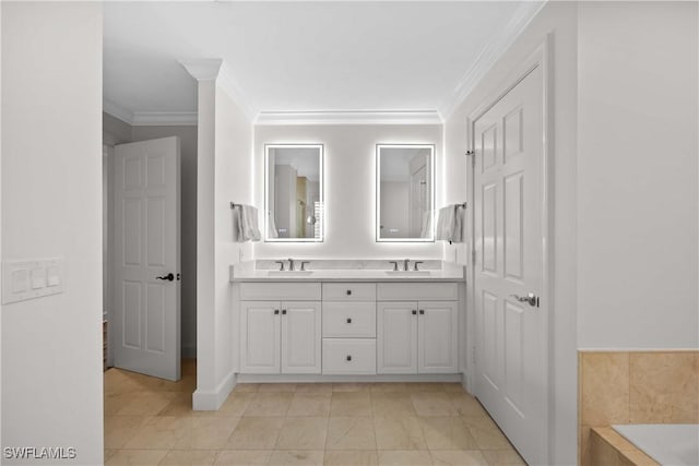 bathroom with a bathing tub, vanity, and ornamental molding