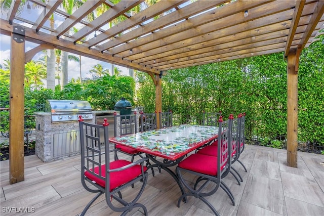 view of patio featuring a pergola, a grill, and an outdoor kitchen